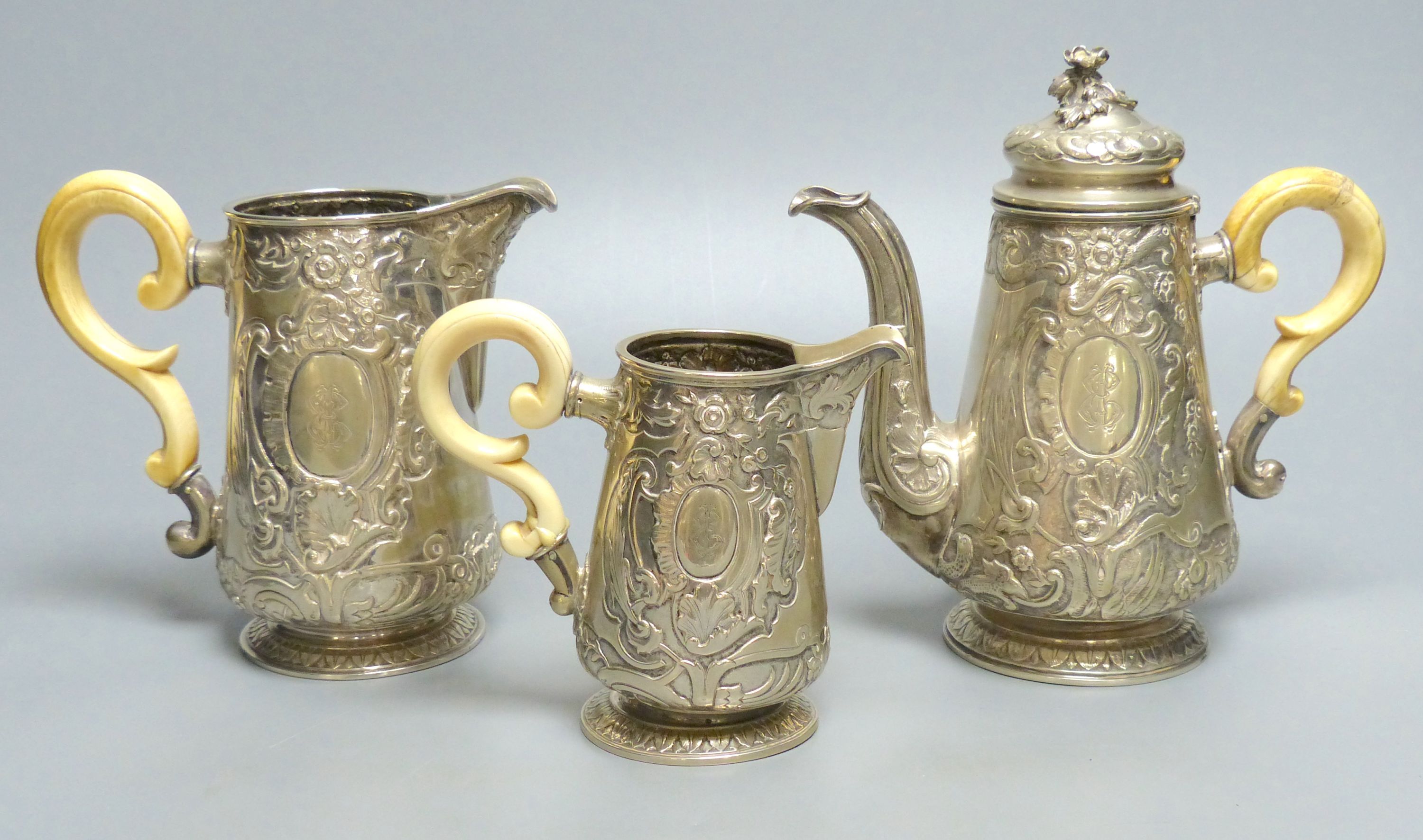 A late 19th/early 20th century Austro-Hungarian embossed 800 standard white metal three piece tea set, gross 35oz,